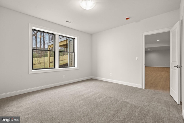 unfurnished bedroom with visible vents, carpet floors, and baseboards