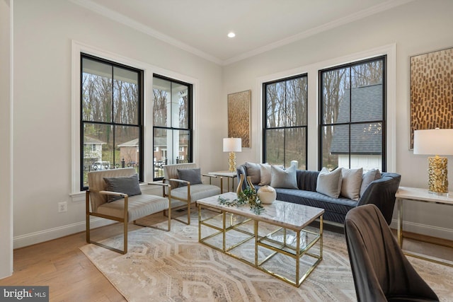 living area with recessed lighting, light wood-type flooring, baseboards, and ornamental molding