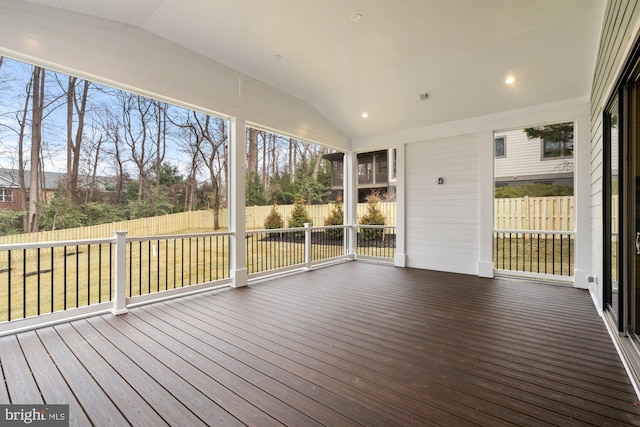 unfurnished sunroom featuring vaulted ceiling and a wealth of natural light