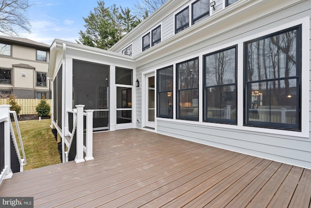 deck with fence and a sunroom