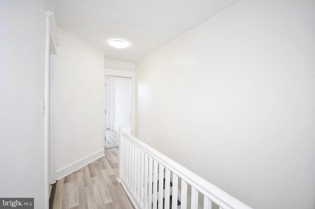 hall with baseboards and light wood-style flooring