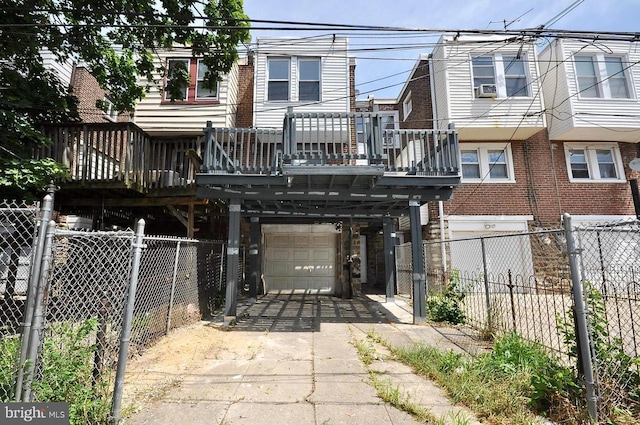 back of property featuring an attached garage, driveway, and fence