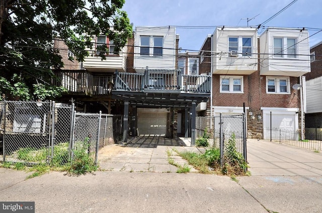 view of property with a garage, driveway, and fence