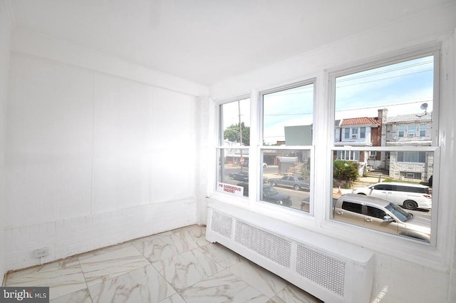 sunroom / solarium featuring radiator