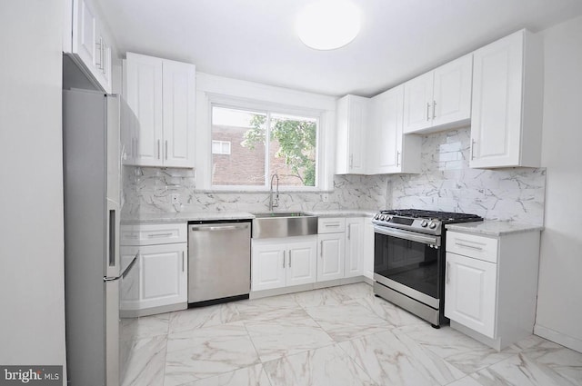 kitchen featuring a sink, tasteful backsplash, marble finish floor, and appliances with stainless steel finishes