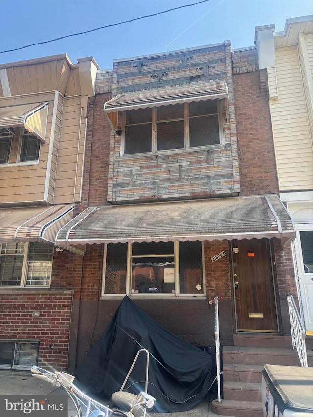 view of front of property featuring brick siding