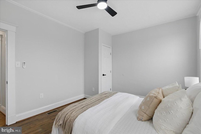 bedroom with visible vents, ceiling fan, baseboards, and wood finished floors