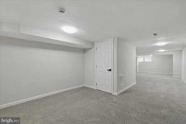 below grade area with visible vents, baseboards, and carpet floors