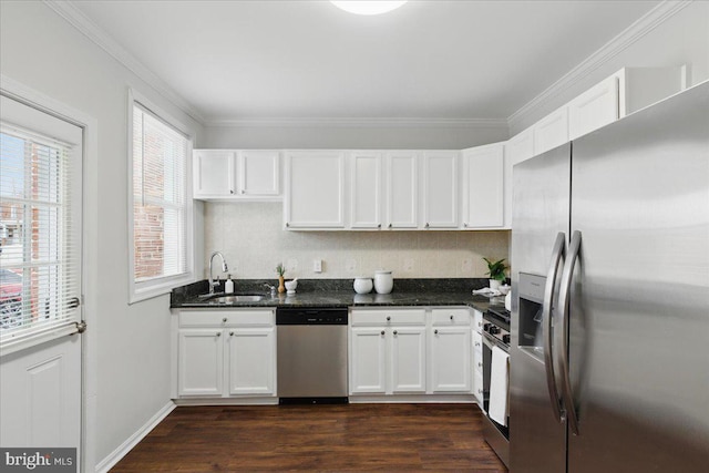 kitchen featuring dark wood finished floors, a sink, stainless steel appliances, white cabinetry, and crown molding