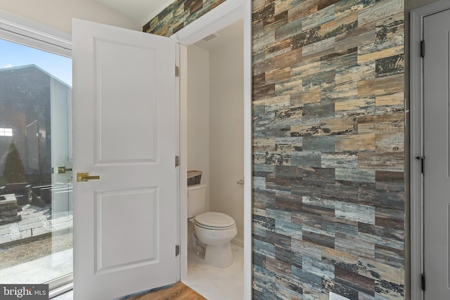 bathroom with toilet and a tile shower