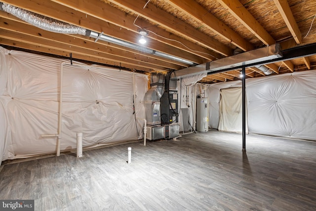 unfinished below grade area featuring heating unit, wood finished floors, and electric water heater