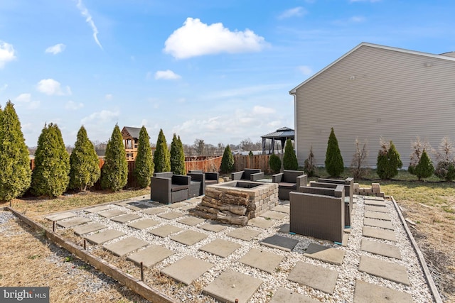 view of patio featuring a gazebo, an outdoor fire pit, and fence