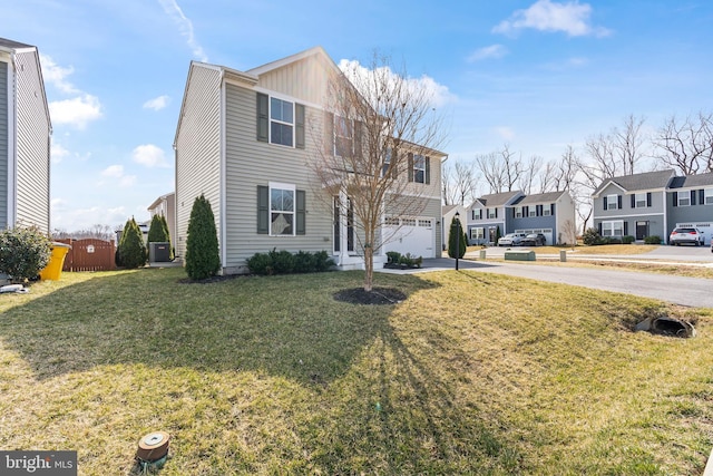 view of front of home with an attached garage, a front lawn, a residential view, central AC unit, and driveway