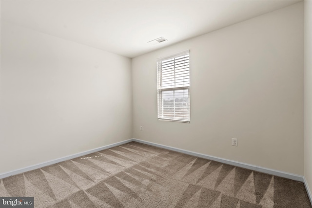 unfurnished room featuring visible vents, carpet floors, and baseboards