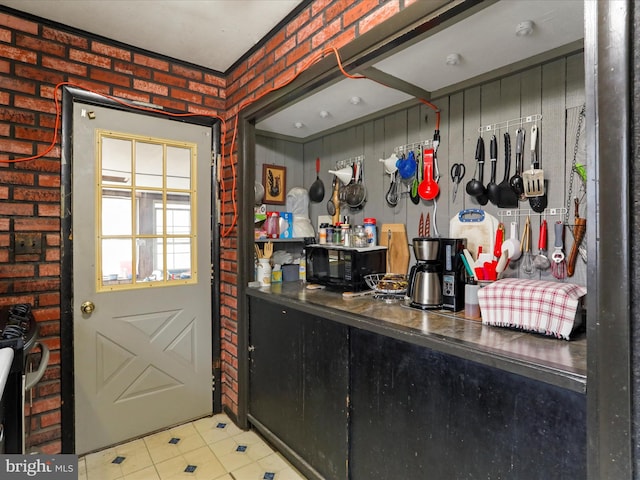 interior space featuring brick wall and black microwave