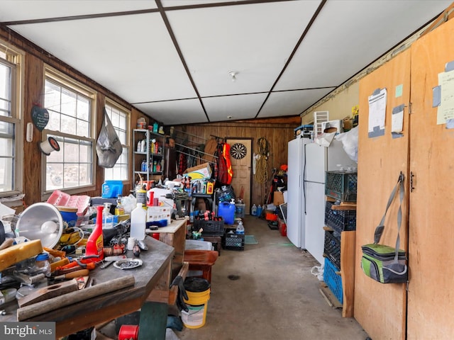 miscellaneous room featuring wood walls and concrete flooring