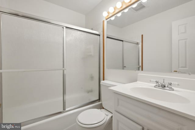 full bathroom with vanity, toilet, combined bath / shower with glass door, and visible vents