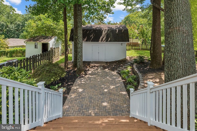 view of yard with an outbuilding, a shed, and fence