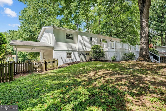 back of property with fence and a lawn