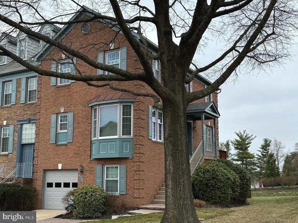 view of home's exterior with an attached garage and brick siding