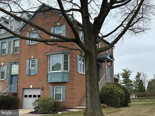 view of home's exterior with an attached garage and brick siding