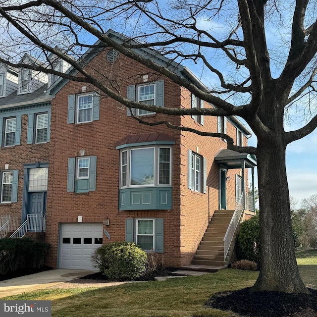 view of front facade featuring brick siding, an attached garage, and driveway