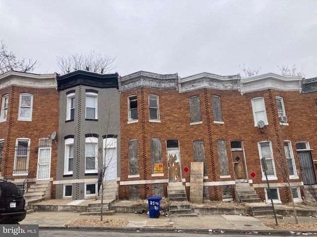 multi unit property featuring brick siding and entry steps