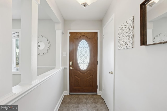 doorway featuring baseboards