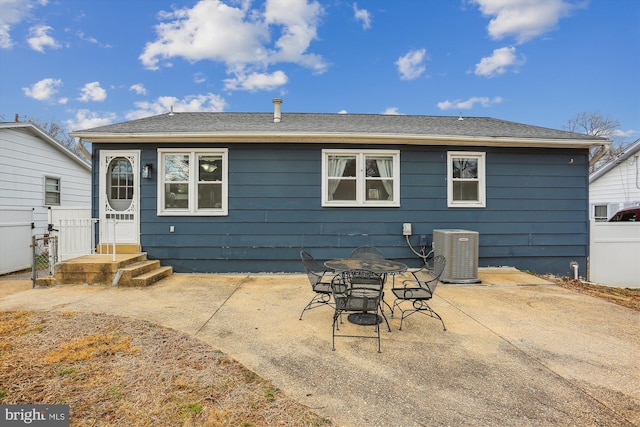 back of property with cooling unit, a patio, and fence