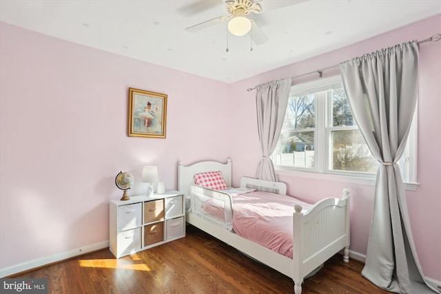 bedroom featuring ceiling fan, baseboards, and wood finished floors