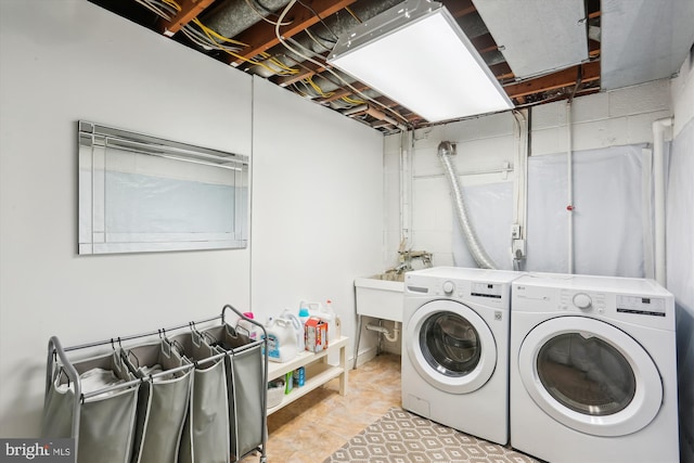 laundry room with a sink, laundry area, and washing machine and clothes dryer