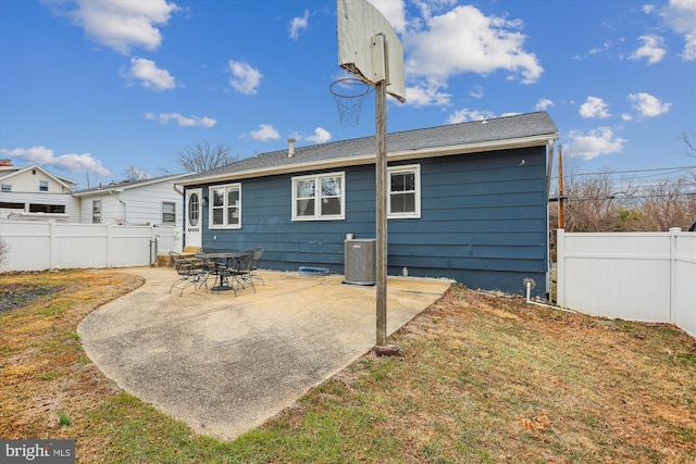 back of house with a patio, a lawn, and fence