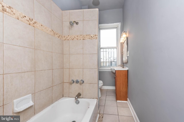 bathroom featuring vanity, baseboards, tile patterned flooring, toilet, and shower / bathtub combination