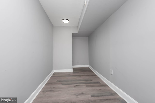 interior space featuring baseboards and wood finished floors
