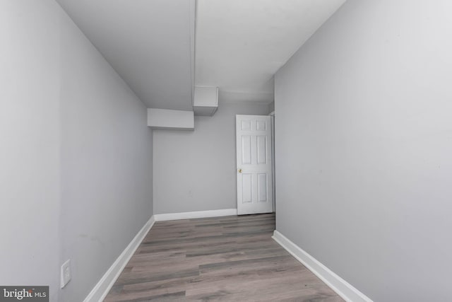 interior space with wood finished floors and baseboards
