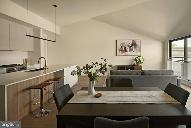 dining room featuring dark wood-type flooring and lofted ceiling