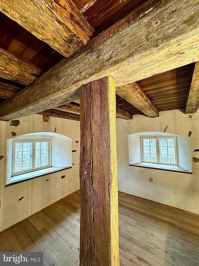 bonus room featuring beam ceiling, wooden ceiling, and wood-type flooring