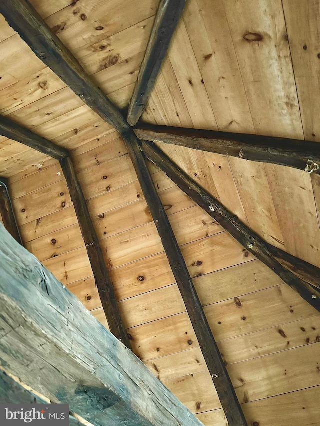 room details with beamed ceiling, wood ceiling, and wood walls