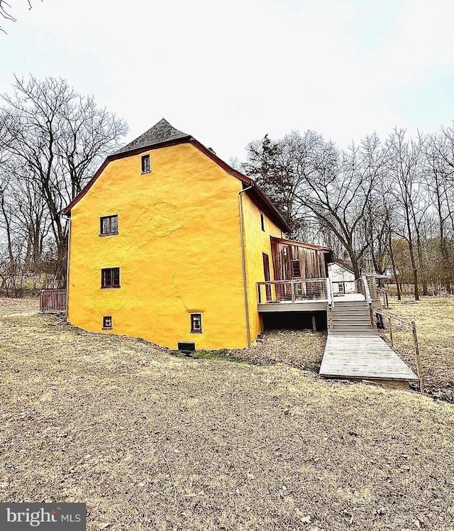 view of home's exterior featuring a deck and stucco siding