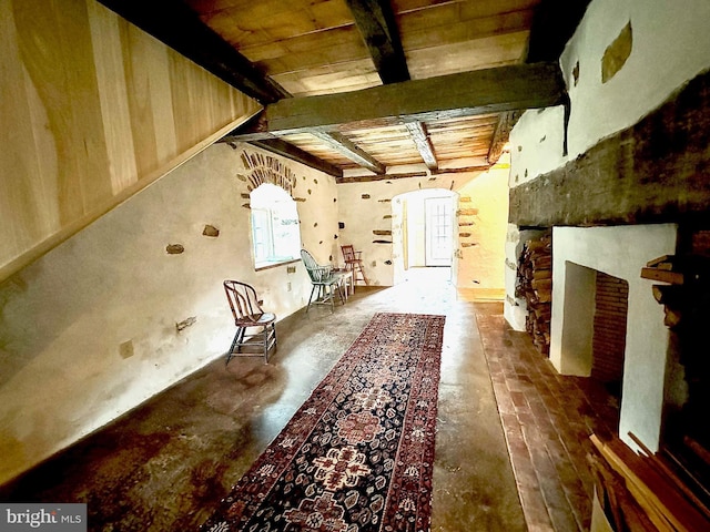 interior space featuring beamed ceiling, wood ceiling, and arched walkways