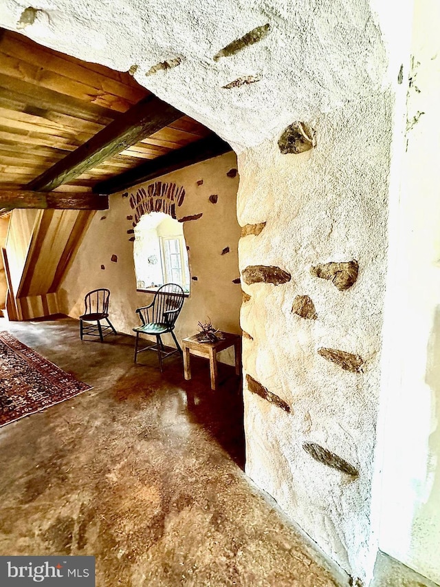 unfurnished room featuring arched walkways, beam ceiling, and wood ceiling