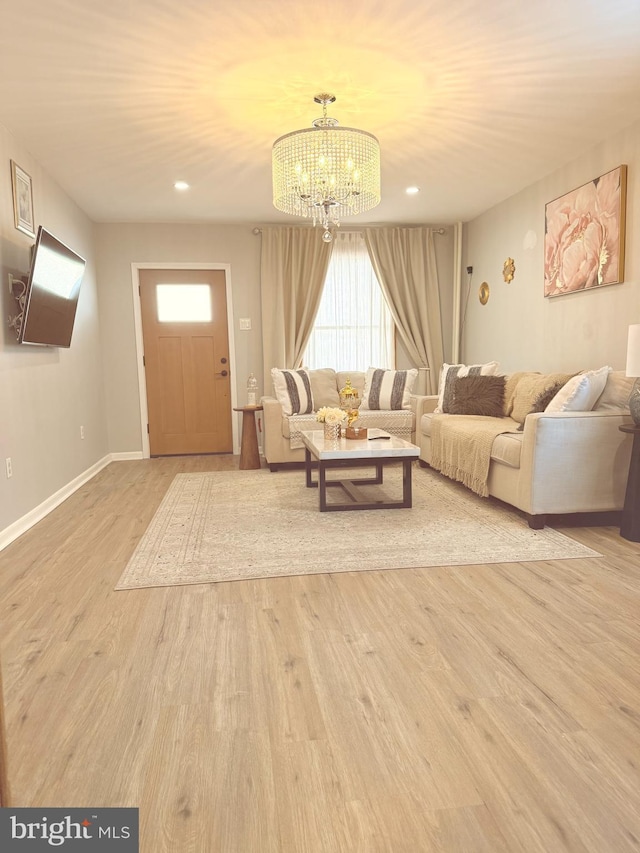 living room with an inviting chandelier, recessed lighting, wood finished floors, and baseboards