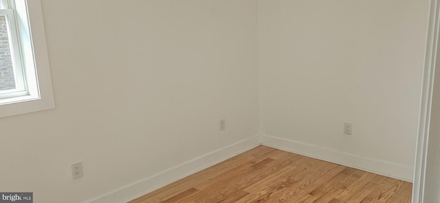 spare room featuring light wood-style flooring and baseboards