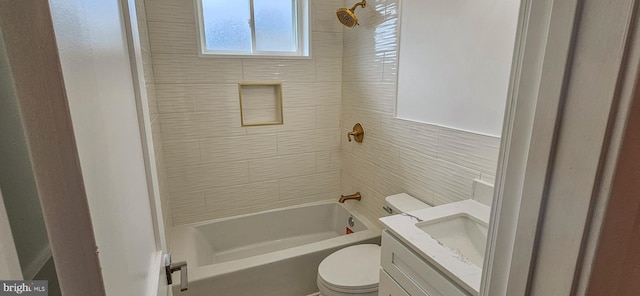 bathroom with toilet, vanity, and shower / tub combination