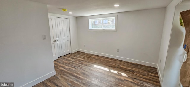 interior space featuring recessed lighting, dark wood-type flooring, and baseboards