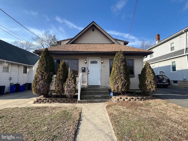 bungalow-style house featuring roof with shingles