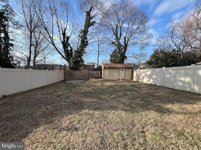 view of yard with a fenced backyard, a storage shed, and an outdoor structure