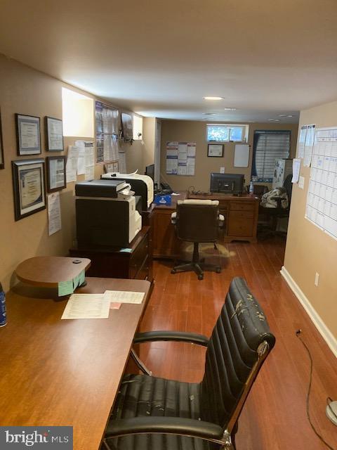 home office featuring baseboards and wood finished floors