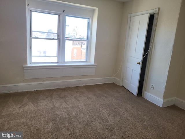 interior space with baseboards and carpet floors