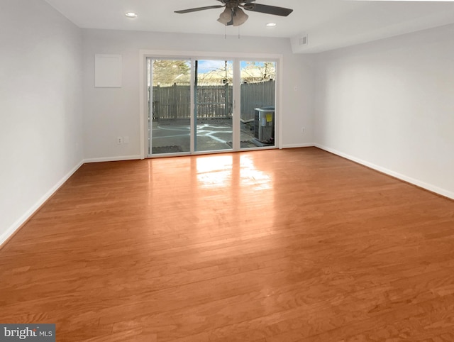 empty room featuring visible vents, baseboards, wood finished floors, and a ceiling fan